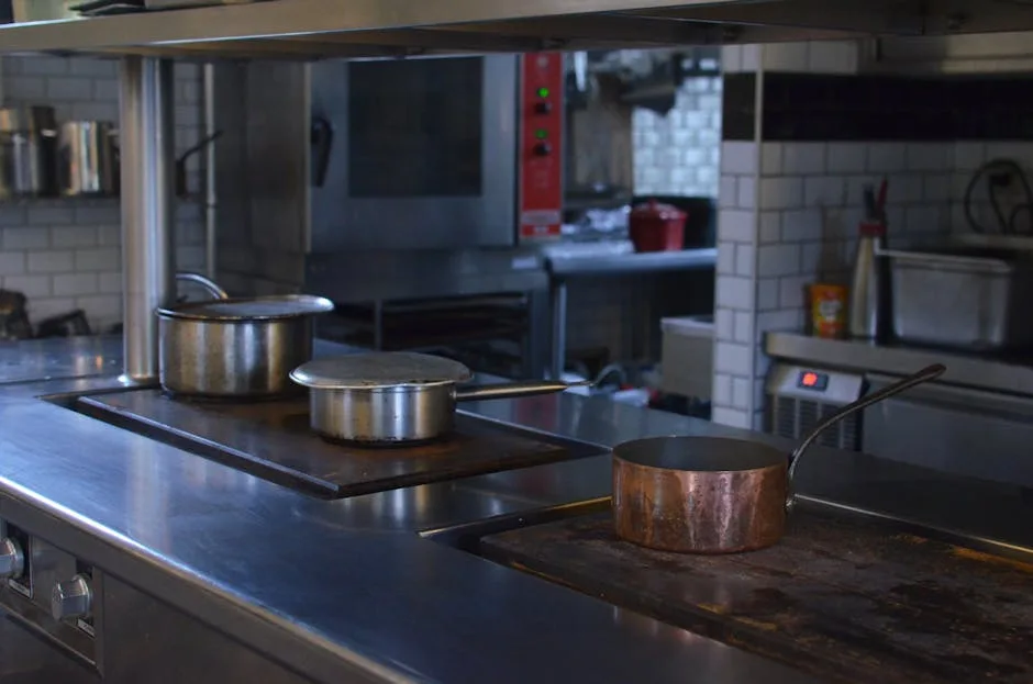 Stainless steel commercial kitchen hood above cooking line in Vineland restaurant